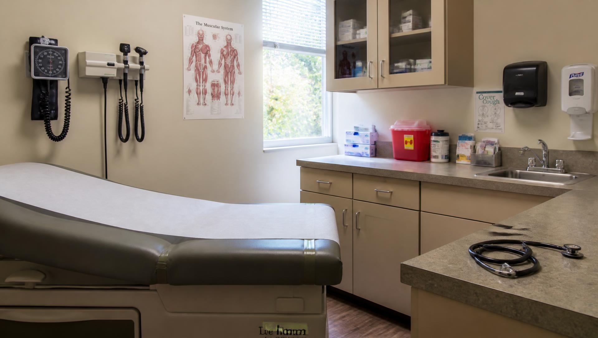 Clinical exam room in a community health clinic with exam table, blood pressure cuff and stethoscope
